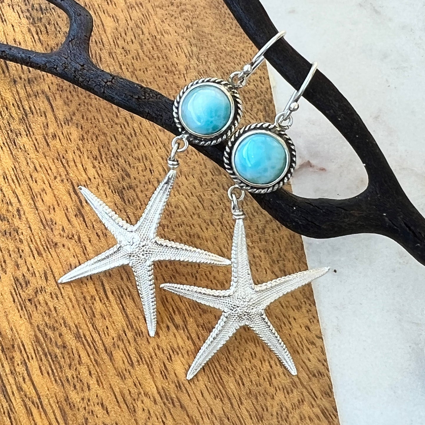Jewelry set with starfish charms on a wooden surface