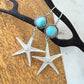 Jewelry set with starfish charms on a wooden surface