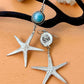 Starfish-shaped earrings with a blue gemstone on a beige surface