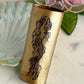 Brass vase with mermaid design on a marble surface
