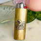 Brass lighter with octopus design on a marble surface
