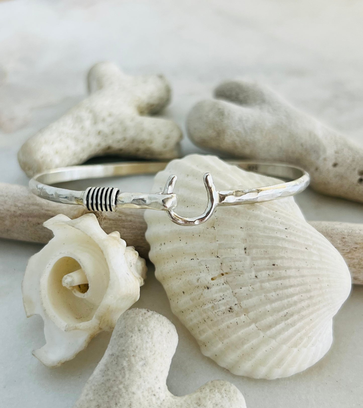 Silver bracelet on seashells